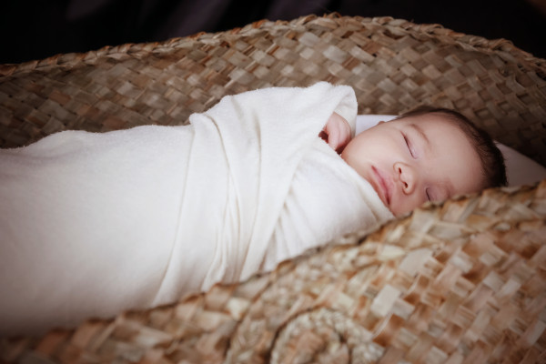 Baby sleeping in wahakura