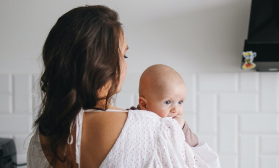 woman in white tank top carrying baby 3875276